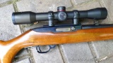Ruger 10/22 carbine with walnut stock and Simmons 4x32 scope. Metal is good to very good with wear