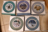 Five Avon Christmas Collector's plates dated 1979, 1978, 1977, 1976, and 1975.