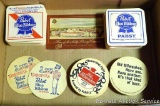 1949 Schlitz Brewing Company postcard; bar coasters including Pabst Blue Ribbon, Old Milwaukee and