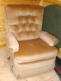 Neutral colored tan recliner is an older style and in very good shape.