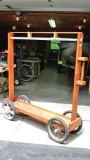 Mobile potting rack with hanging basket rod allows you to get your flowers going early by wheeling