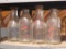 Collection of 4 clear glass milk bottles including Pope, Christoph's and West's. Tallest bottle