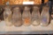 Five clear glass dairy bottles. Brands include Cloverland Dairy, Kee & Chapell and Hartway's Dairy.