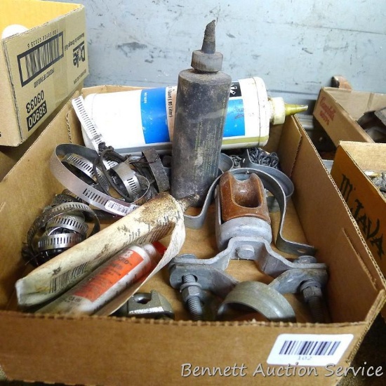 Assortment of radiator clamps, largest 4-1/2" round, conduit clamps, insulator and more.