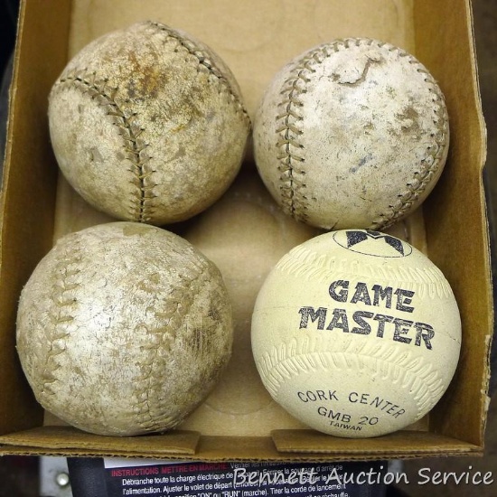 Four softballs including one Game Master