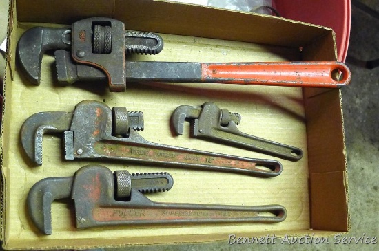 Several pipe wrenches, including 18", 14" and 7". Jaws show some wear.
