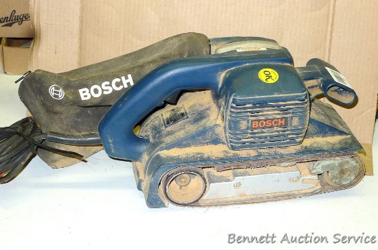 Bosch belt sander, includes dust bag. Belt is 3-1/2" x 10". Works.