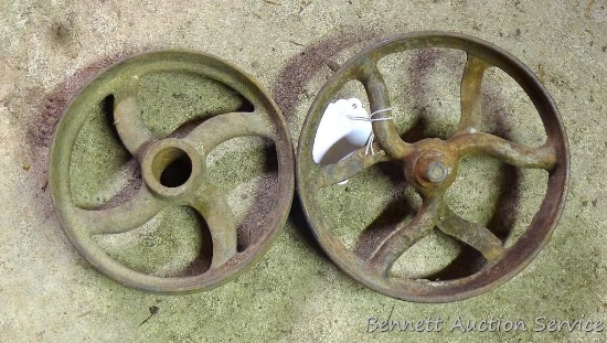 Two cast iron wheels largest is 8" diameter.