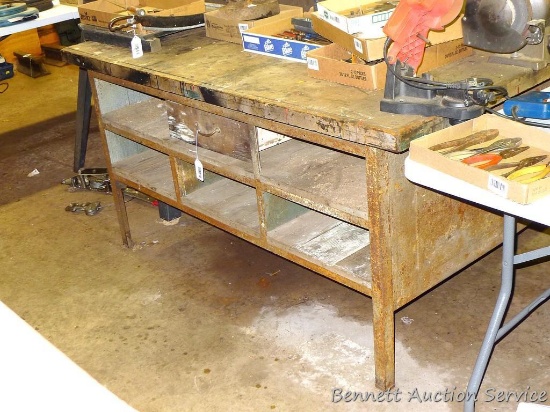 Work bench has metal frame and wooden top 82" x 50" x 32" tall. Has storage compartments on both