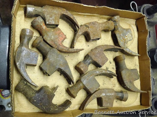 Assortment of metal claw hammer heads with broken handles. Appear to be in good shape, just need