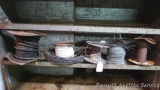 Partial rolls of electrical wire of various sizes.