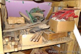 Pile of nifty wooden components including carriage or buggy wheel spokes, table legs and parts, old