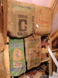 Four old burlap feed sacks, each approx. 2'x3'.