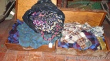 Two old suitcases filled with wool and other flannel shirts, plus a braided rug project. No