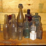 Collection of 19 bottles including vintage green, brown and white glass,