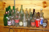 No shipping. Collection of glass soda bottles including Coke, 7-Up, Stuber, Stamm, Nehi and more.