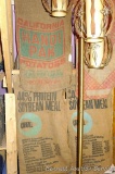 Four burlap feed sacks are each approx. 3' x 2'.