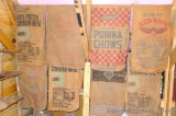 Eight burlap feed sacks are each approx. 3' x 2'.