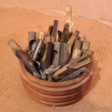 Assortment of spires for maple tree tapping. Includes wooden and metal taps.