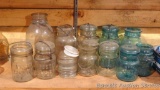 Collection of 11 glass jars with glass lids. Includes Ball, Foster and McDonald jars.