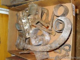 Assortment of cast iron pieces including hooks, bushings and more