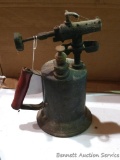 Brass blow torch with original handle stands nearly a foot tall. Chipped handle. Will polish up