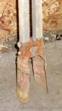 Post hole digger with wooden handles and stands 59