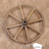 Antique wooden spoked wheel with metal rim, may be from a baby buggy. Measures 11.5