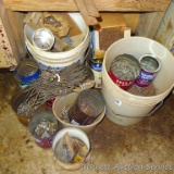 Assortment of nails including roofing nails, finishing nails and more. All on floor.