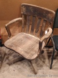 Antique wooden swivel chair. Measures 22