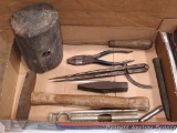 Assortment of tools including a screwdriver, aluminum levels, hammer, and wooden mallet head