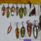 Over a dozen spoons and other fishing lures.