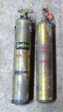 Two brass fire extinguishers. One is labeled Fitter Model A and the other is General Quit Aid