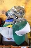 Assortment of camo and regular hats.