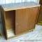 Two sided console cabinet has storage and sliding doors on each side. Measures 32