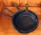 Four smaller cast iron skillets. Three are 8