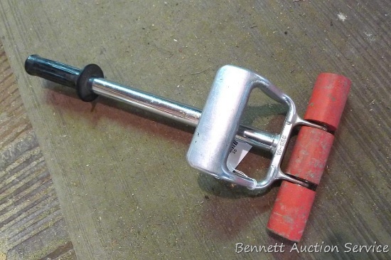 Vinyl flooring roller is approx 8" wide by 27" long. Collapsible handle.