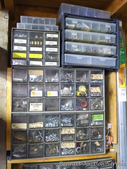Several storage cabinets filled with self locking nuts, screws, brass nuts and bolts, more. Largest