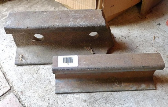 Two pieces of railroad track, biggest is 10"x 4". Would make a good anvil.