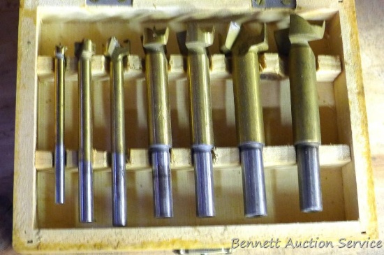 Set of Forstner bits, largest is 1" in a wooden carrying case.