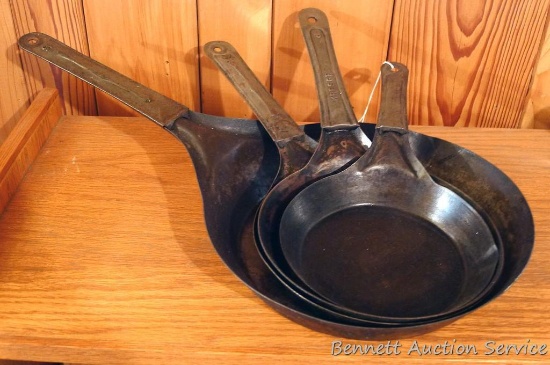 Four stamped steel fry pans. Largest is 11", smallest is 7".