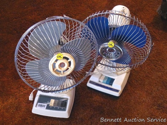 Two oscillating three speed table top fans, each are about 20" tall.