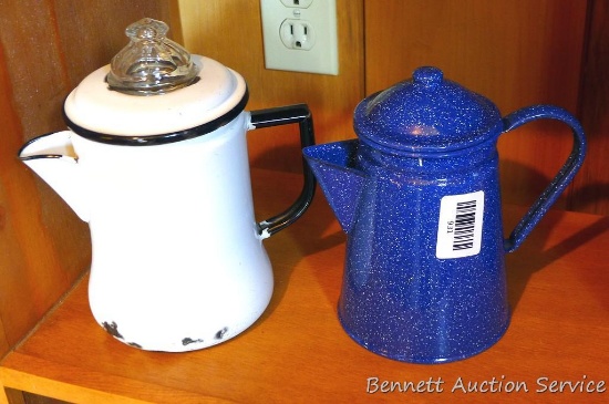 Two enamelware coffee pots, both have a stem and basket. Tallest is approx 9".