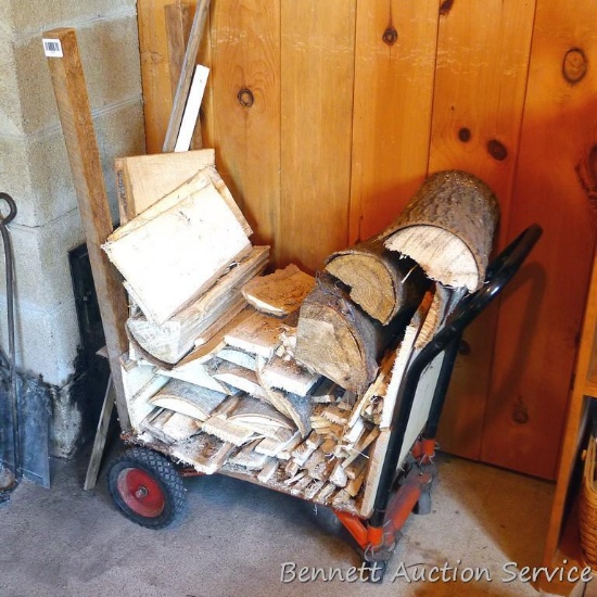 Several pieces of firewood on a rolling rack. Rack stands approx 16"x 25" at the base.