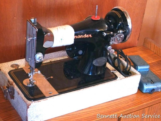 Vintage Commander portable sewing machine looks to be in good condition. Case shows wear.
