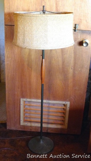 Retro floor lamp has a wooden pole and stands 50" tall.