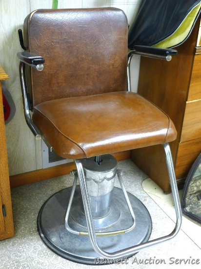 Older style beauty parlor or salon chair. Upholstery is in good condition. This would make a great