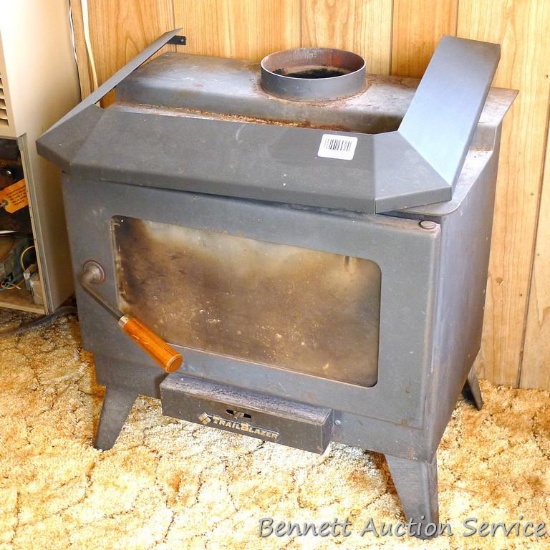 No shipping. Trail Blazer model 1700 fire view woodstove with fire brick lining is about 24" tall.