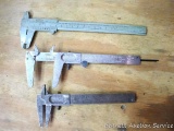 Inside & outside calipers. Some surface rust. Largest measures up to 4-1/2