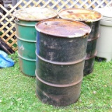 Three 55 gallon steel drums, includes lids and clamps.